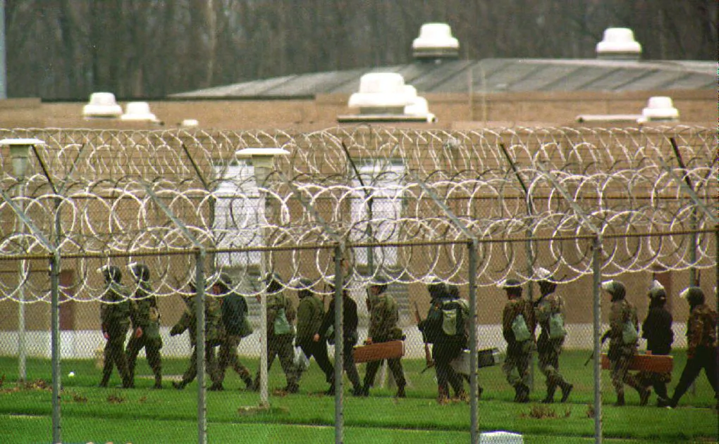 Prison officers enter the Southern Ohio Correctional Institute in front of Cellblock L, as prisoners inside continue to hold eight guards hostage, Lucasville, on April 13, 199. (Eugene Garcia/AFP via Getty Images)