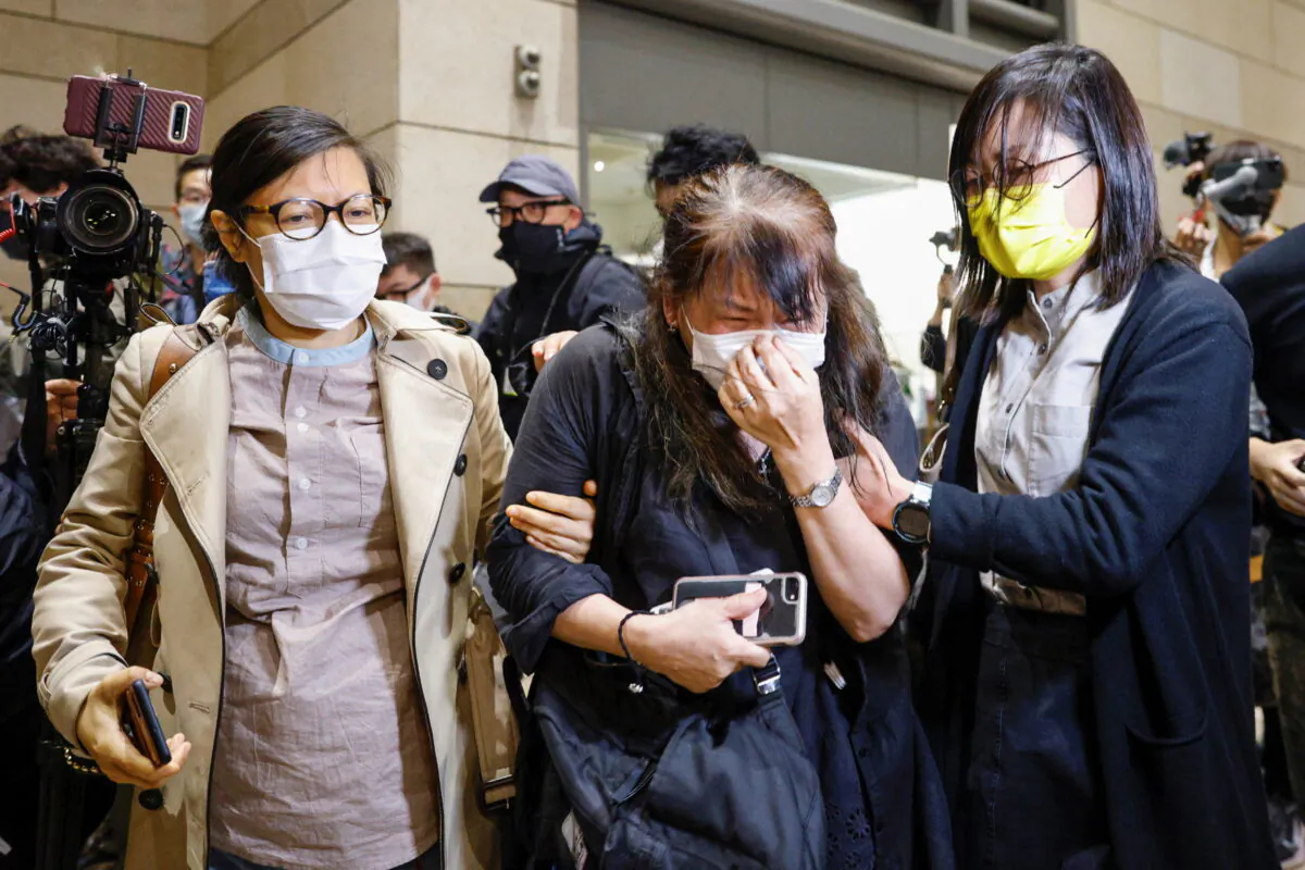 Supporter of pro-democracy activists cries after court grants bail to 15 of 47 democracy activists charged with subversion over national security law at West Kowloon Magistrates' Courts, in Hong Kong, China, on March 4, 2021. (Tyrone Siu/Reuters)