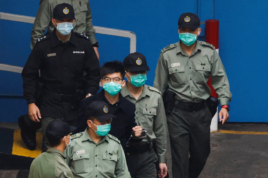 Pro-democracy activist Joshua Wong walks to a prison van to head to court with other activists, over a national security law charge, in Hong Kong, China, on March 4, 2021. (Tyrone Siu/Reuters)