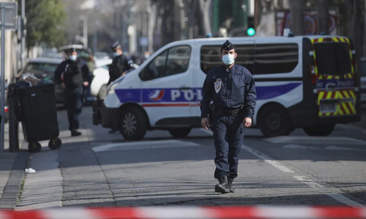 Police officers cordon off the area after a man visibly brandished a knife outside a Jewish school and a kosher market in Marseille, southern France, on March 5, 2021. (Daniel Cole/AP Photo)
