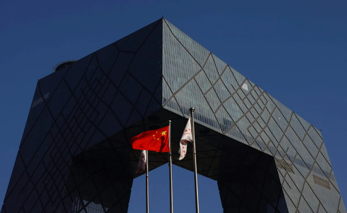 A Chinese flag flutters outside the CCTV headquarters, the home of Chinese state media outlet CCTV and its English-language sister channel CGTN, in Beijing, China on Feb. 5, 2021. (Carlos Garcia Rawlins via Reuters)