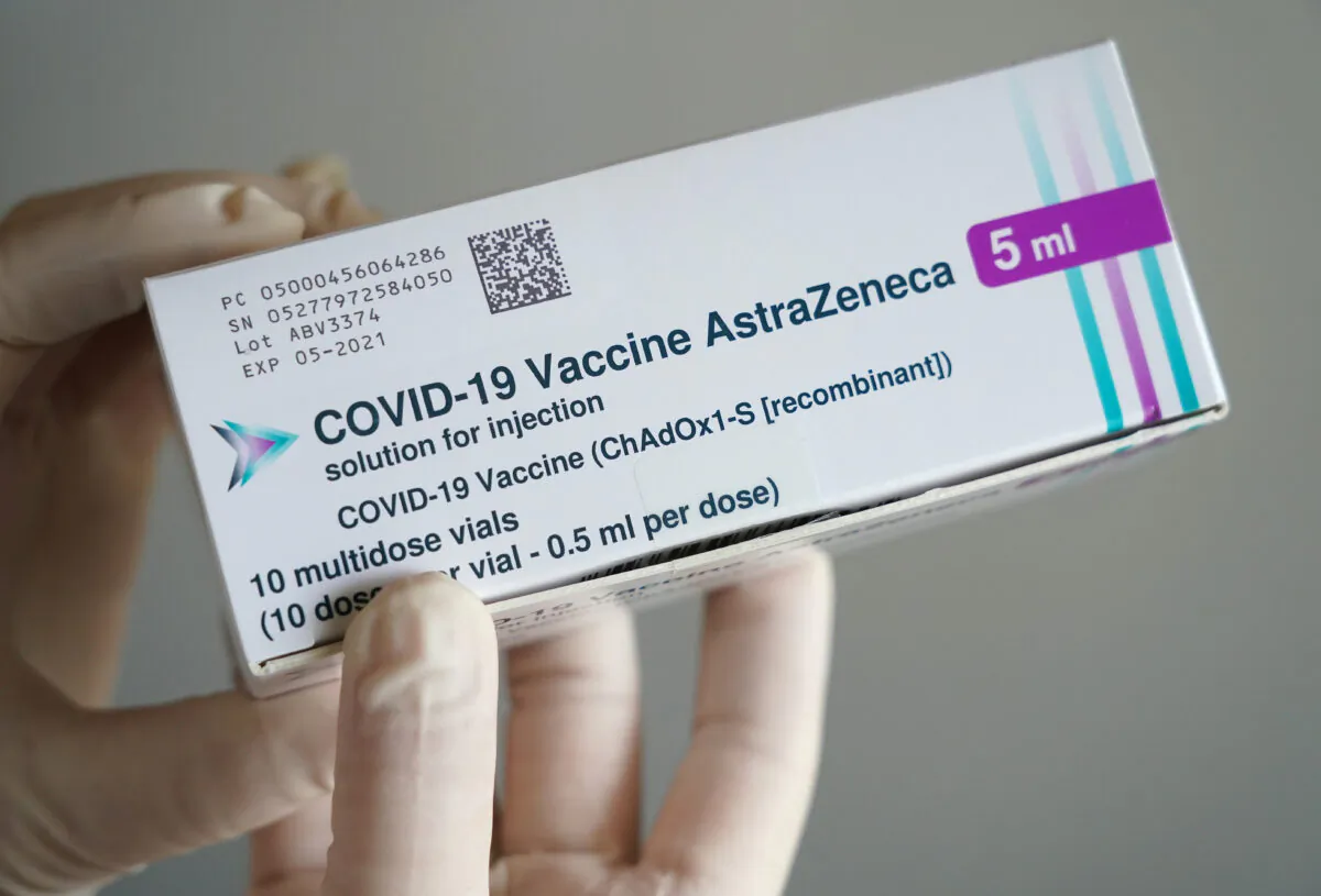 A nurse holds a box containing viles of the AstraZeneca adenovirus vector vaccine. (Sean Gallup/Getty Images)
