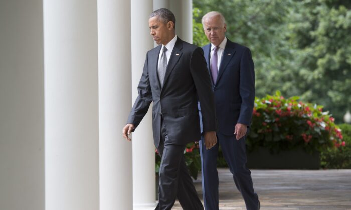 President Barack Obama walks alongside Vice President Joe Biden as they arrive to speak about the Supreme Court's ruling to uphold the subsidies that comprise the Affordable Care Act, known as Obamacare, in the Rose Garden of the White House in Washington. (Saul Loeb/AFP via Getty Images)