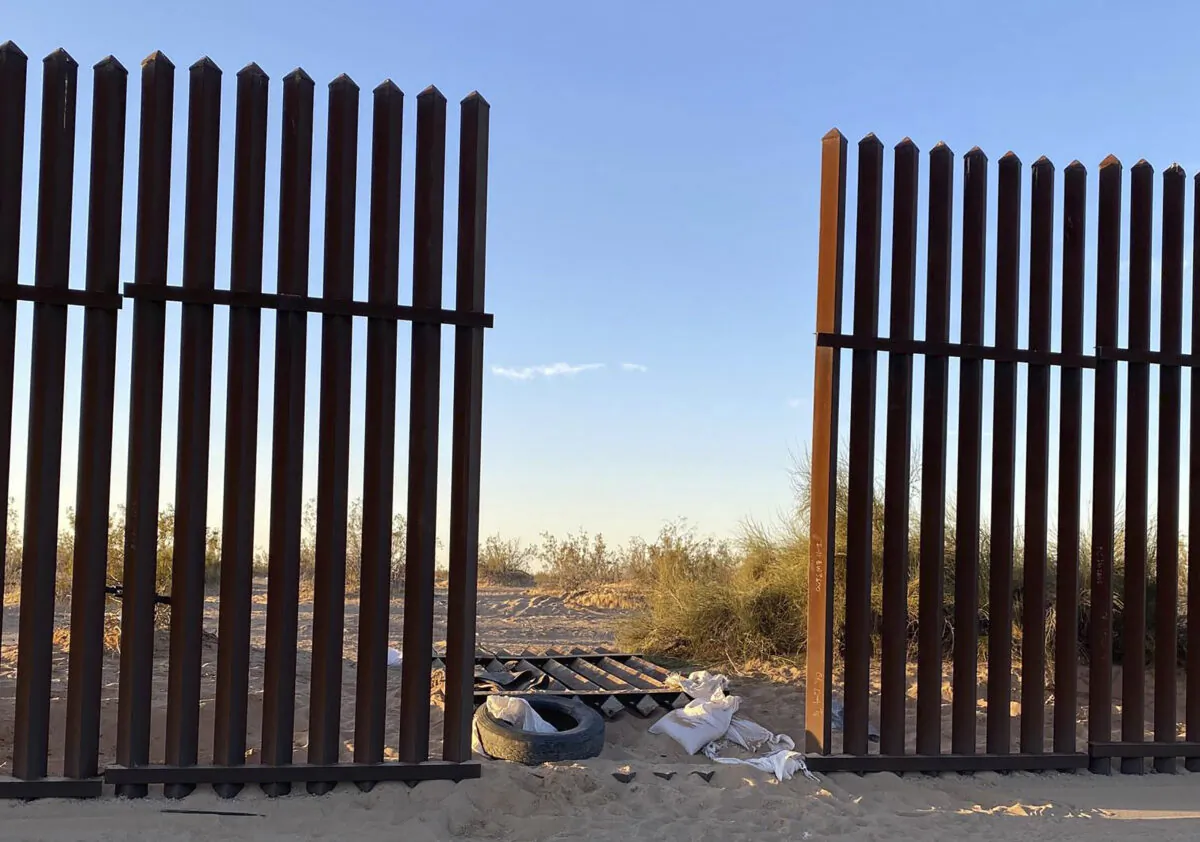 This file photo shows a hole cut into Southern California's border fence with Mexico on March 3, 2021. (U.S. Customs and Border Protection via AP)