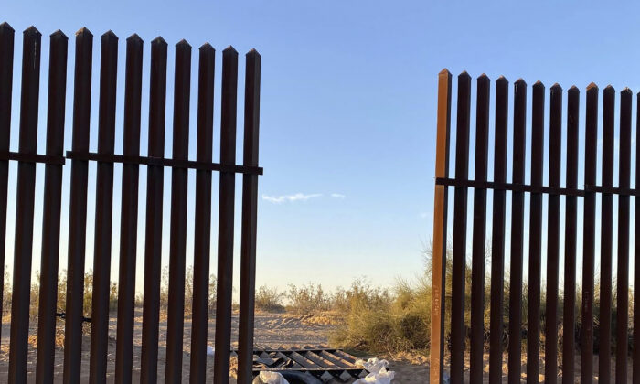 This file photo shows a hole cut into Southern California's border fence with Mexico on March 3, 2021. (U.S. Customs and Border Protection via AP)