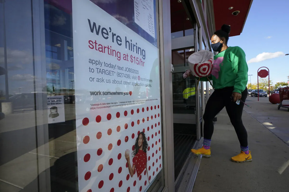 A passerby walks past a hiring sign while entering a Target store in Westwood, Mass., on Sept. 30, 2020. (Steven Senne/File/AP Photo)