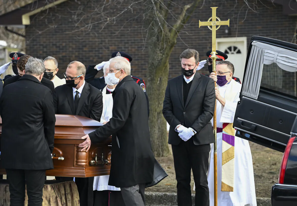Hockey hall-of-fame legend Wayne Gretzky (2nd R) cries as he watches the casket of his father, Walter Gretzky, be carried from the church during a funeral service in Brantford, Ont., on March 6, 2021. (The Canadian Press/Nathan Denette)