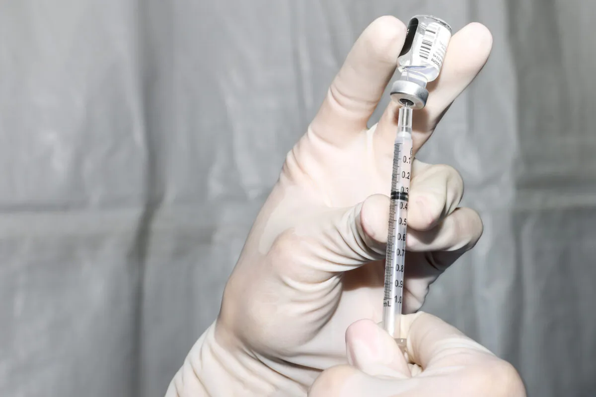 A COVID-19 vaccine is prepared in Colorado, in a file image. (Michael Ciaglo/Getty Images)