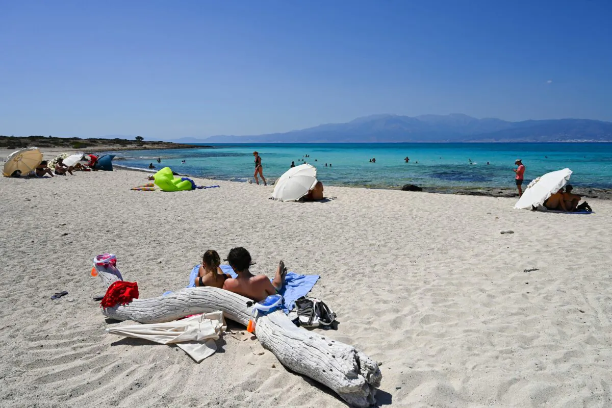 People enjoy the sea on a beach of the small island of Chrysi, south of Crete, on July 26, 2020. (Aris Messinis/AFP via Getty Images)