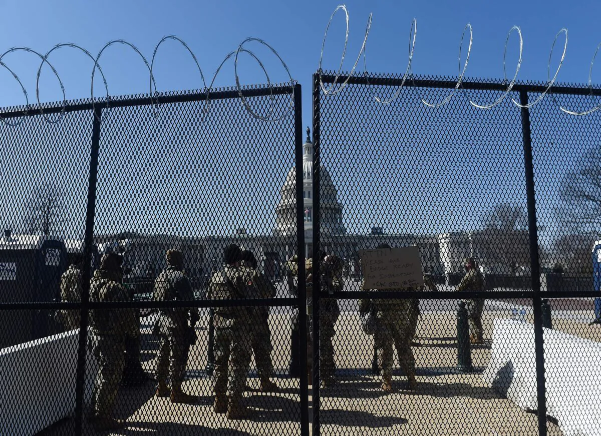 Members of the National Guard watch a checkpoint on Capitol Hill, Washington, on March 5, 2021. (Olivier Douliery/AFP via Getty Images)
