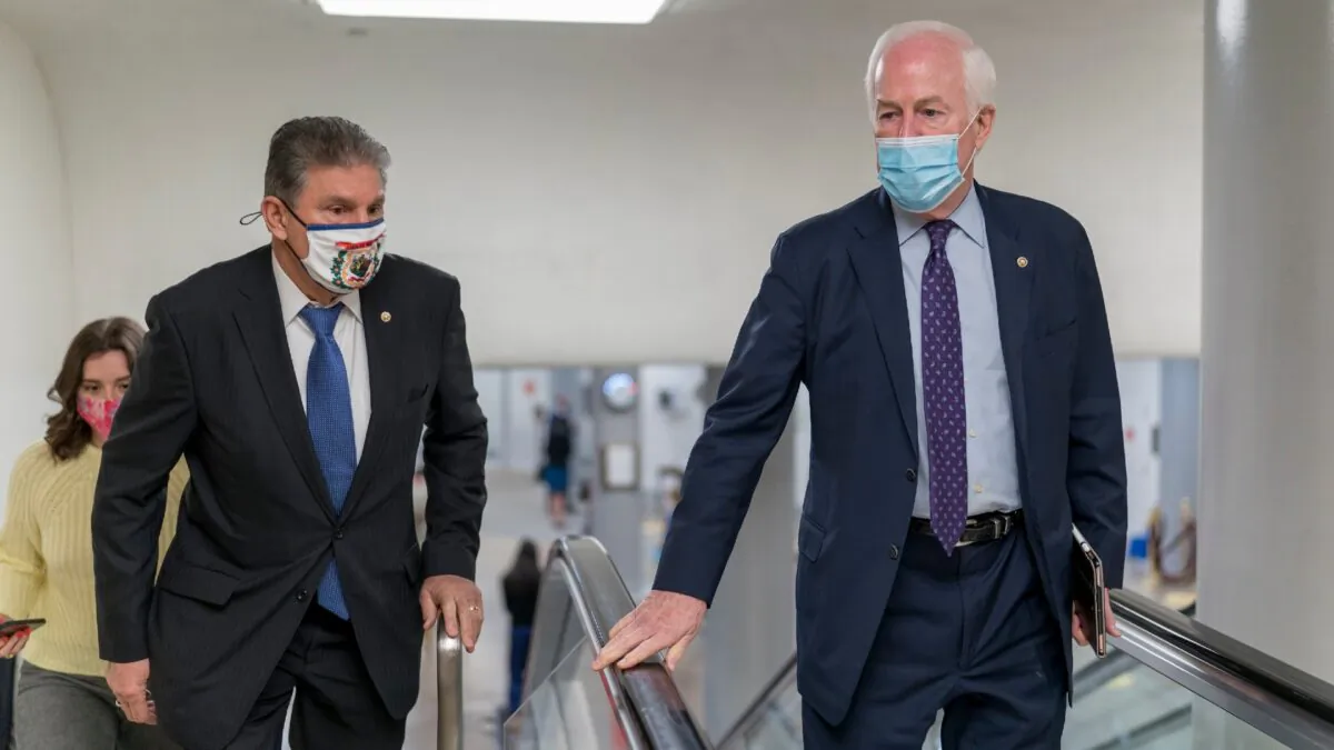 Sen. Joe Manchin (D-W.Va.) left, and Sen. John Cornyn (R-Texas), head to the chamber as the Senate steers toward a voting marathon on the Democrats' $1.9 trillion COVID-19 relief bill at the Capitol on March 5, 2021. (J. Scott Applewhite/AP)