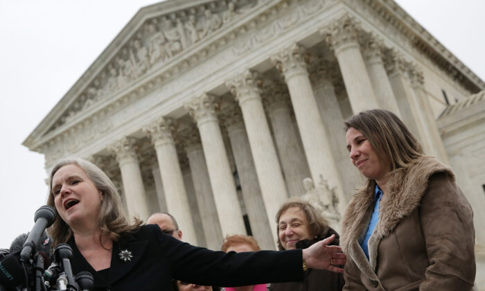 File photo of Sharon Fast Gustafson (L), in her capacity as an attorney representing plaintiff Peggy Young (R), answers questions outside the U.S. Supreme Court, in Washington, on Dec. 3, 2014. (Win McNamee/Getty Images)