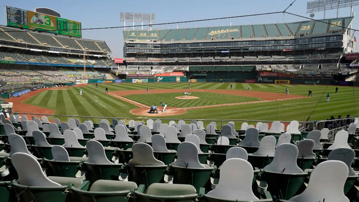 Cutouts are seated at Oakland Coliseum as Chicago White Sox's Dallas Keuchel, center, pitches to Oakland Athletics' Tommy La Stella during Game 2 of an American League wild-card baseball series in Oakland, Calif., on Sept. 30, 2020. (Eric Risberg/AP, File)