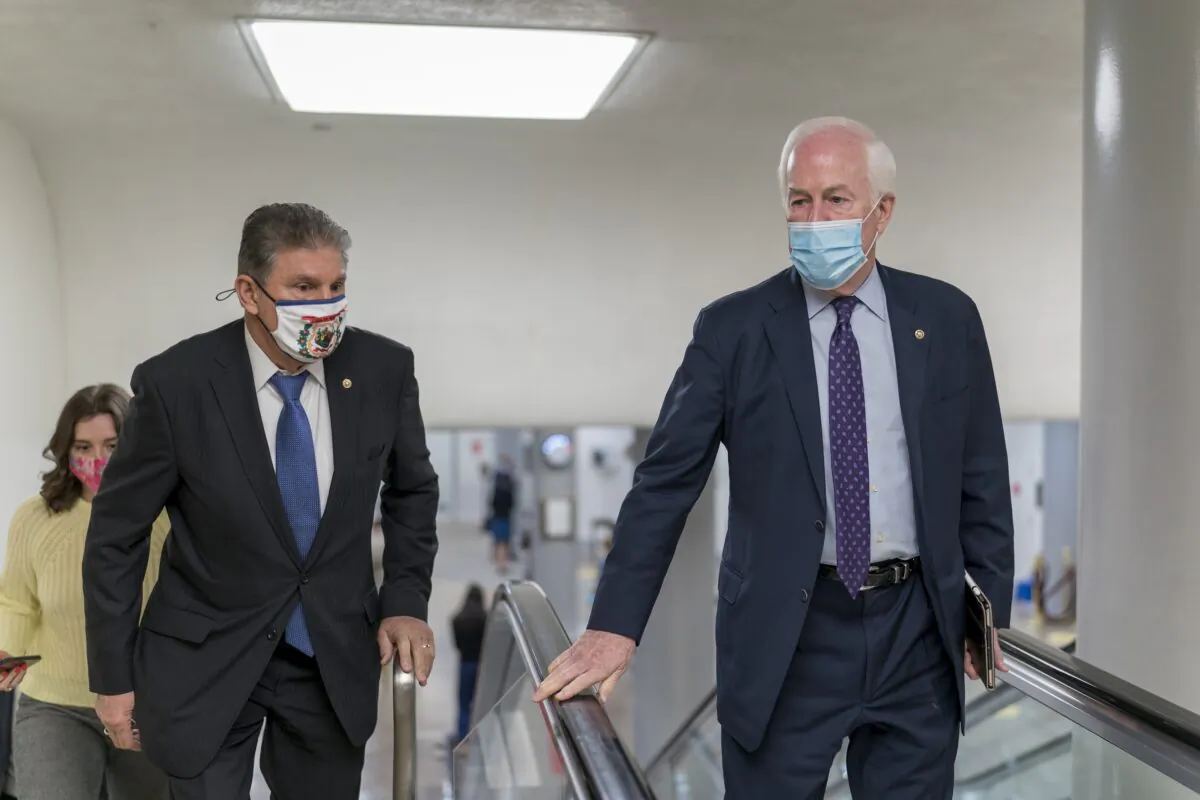Sens. Joe Manchin (D-W.Va.), left, and John Cornyn (R-Texas) head to the chamber at the Capitol in Washington on March 5, 2021. (J. Scott Applewhite/AP Photo)