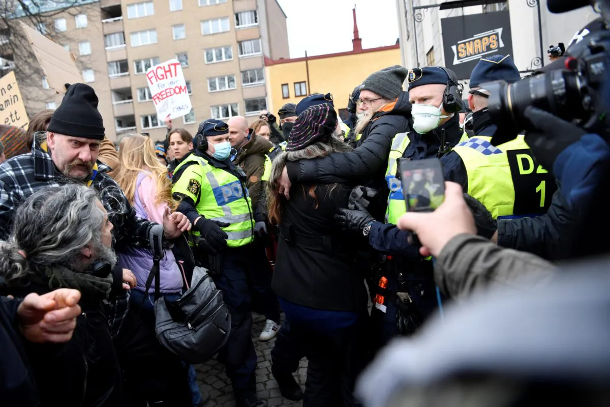 Swedish police break up a demonstration of CCP virus restrictions opponents protesting against a ban on large gatherings, in Stockholm, Sweden, on March 6, 2021. (Henrik Montgomery/TT News Agency via Reuters)