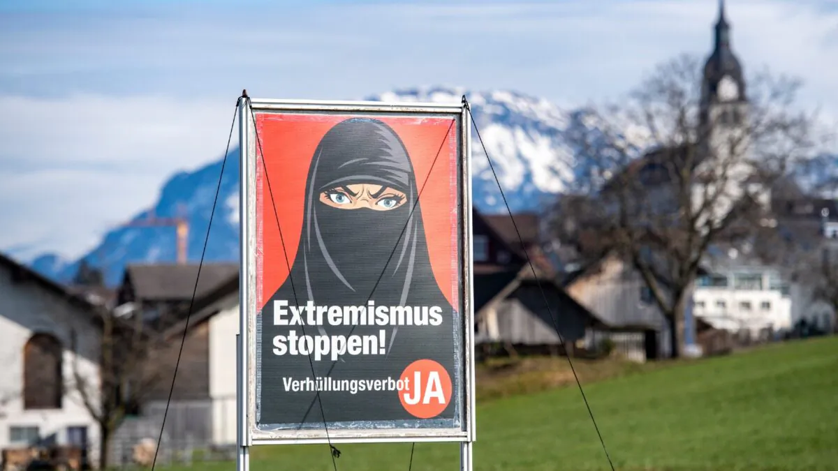 A poster supporting the initiative 'Yes to a ban on covering the face' is displayed at the village Buochs, Switzerland, on Feb. 16, 2021. (Urs Flueeler/Keystone via AP)