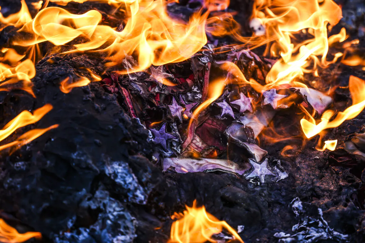 Members of the Communist Party USA and other radical groups burn an American flag on the steps of the Colorado State Capitol in Denver, Colo., on Jan. 20, 2021. (Michael Ciaglo/Getty Images)