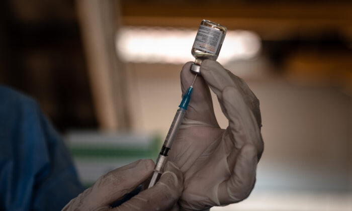A medical officer prepares a dose of China's Sinovac COVID-19 vaccine during a mass vaccination program in Yogyakarta, Indonesia, on March 2, 2021. (Ulet Ifansasti/Getty Images)