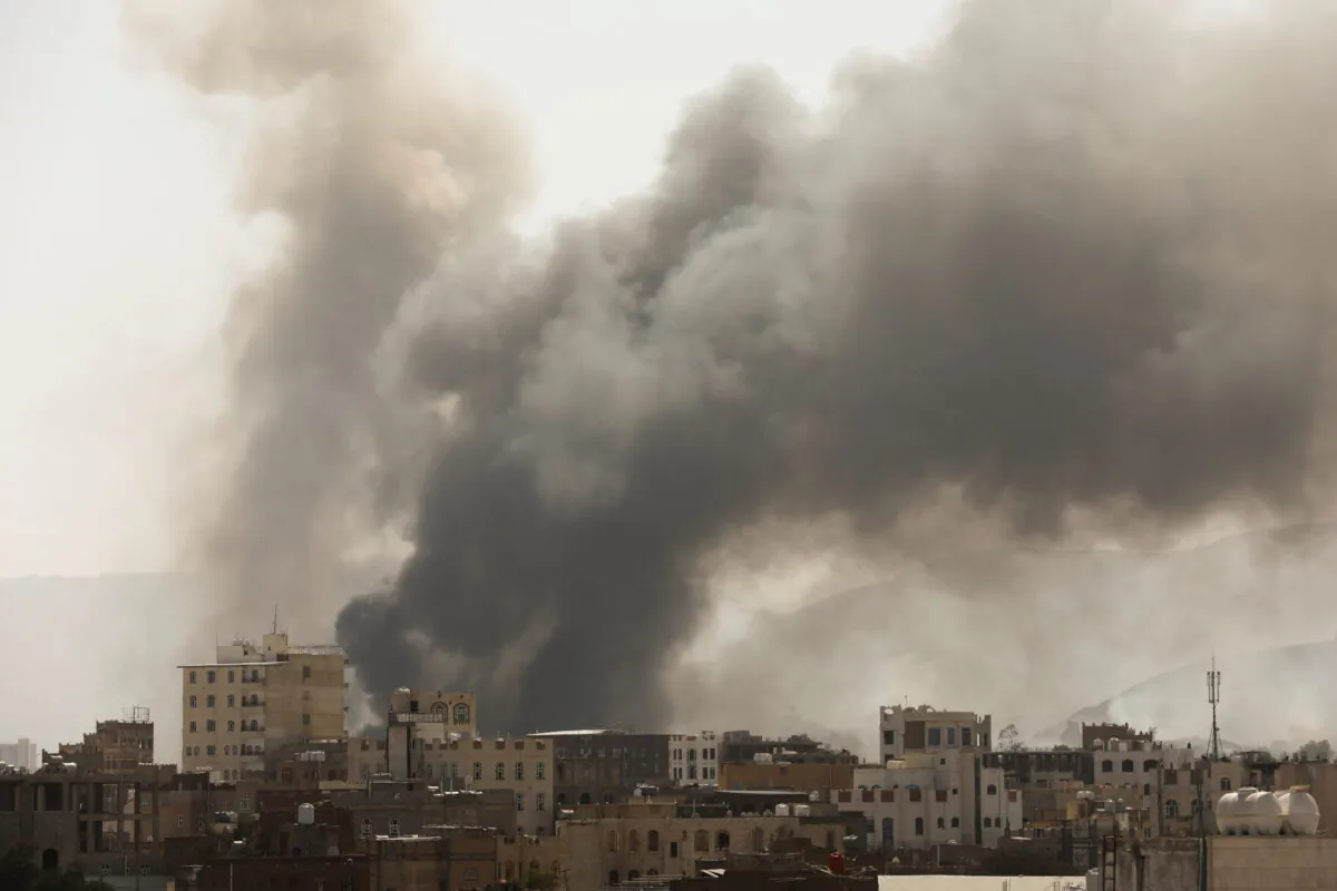 Smoke billows from the site of Saudi-led air strikes in Sanaa, Yemen, on March 7, 2021. (Khaled Abdullah/Reuters)
