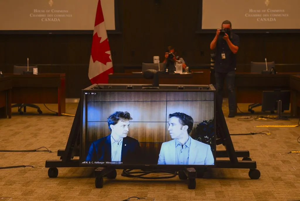 Marc Kielburger (L) and Craig Kielburger appear as witnesses via videoconference during a House of Commons finance committee in the Wellington Building in Ottawa on July 28, 2020. (Sean Kilpatrick/The Canadian Press)