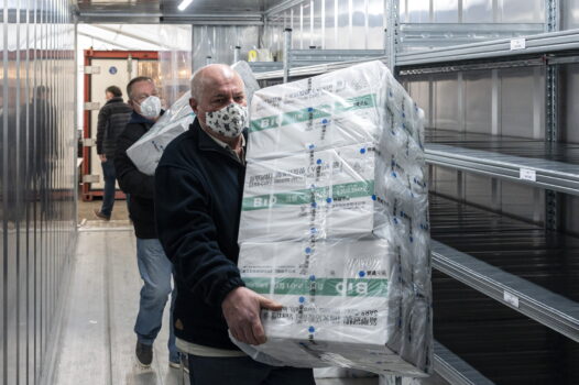 Employees unload the newly arrived coronavirus vaccines from Chinese pharmaceutical company Sinopharm