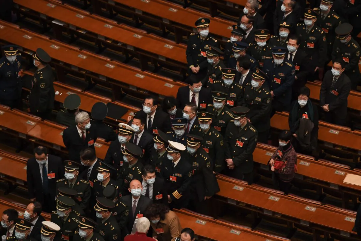Military delegates leave after China's rubber-stamp legislature’s conference at the Great Hall of the People in Beijing, China on March 8, 2021. (Noel Celis/AFP via Getty Images)