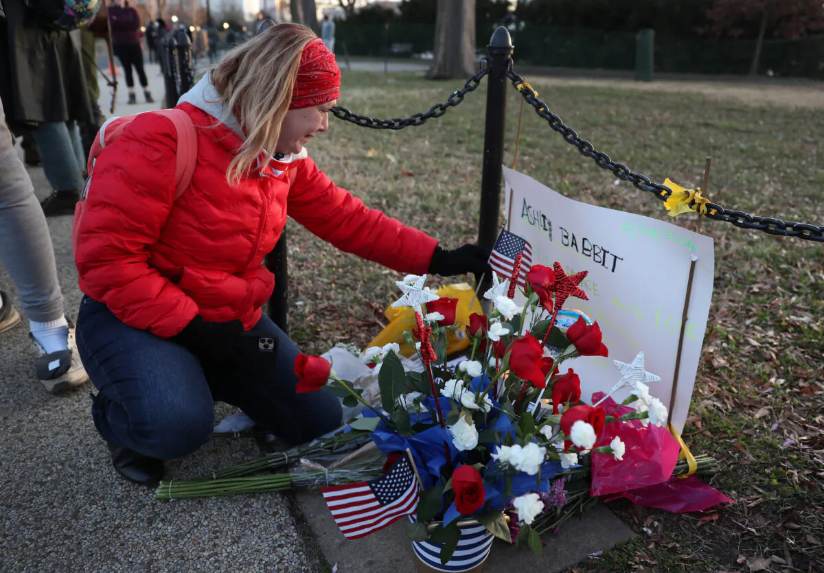 Melody Black, from Minnesota, becomes emotional as she visits a memorial setup near the U.S. Capitol Building for Ashli Babbitt who was killed in the building the day prior, in Washington on Jan. 7, 2021. (Joe Raedle/Getty Images)