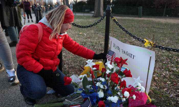 Melody Black, from Minnesota, becomes emotional as she visits a memorial setup near the U.S. Capitol building for Ashli Babbitt who was killed in the building the day prior, in Washington on Jan. 7, 2021. (Joe Raedle/Getty Images)