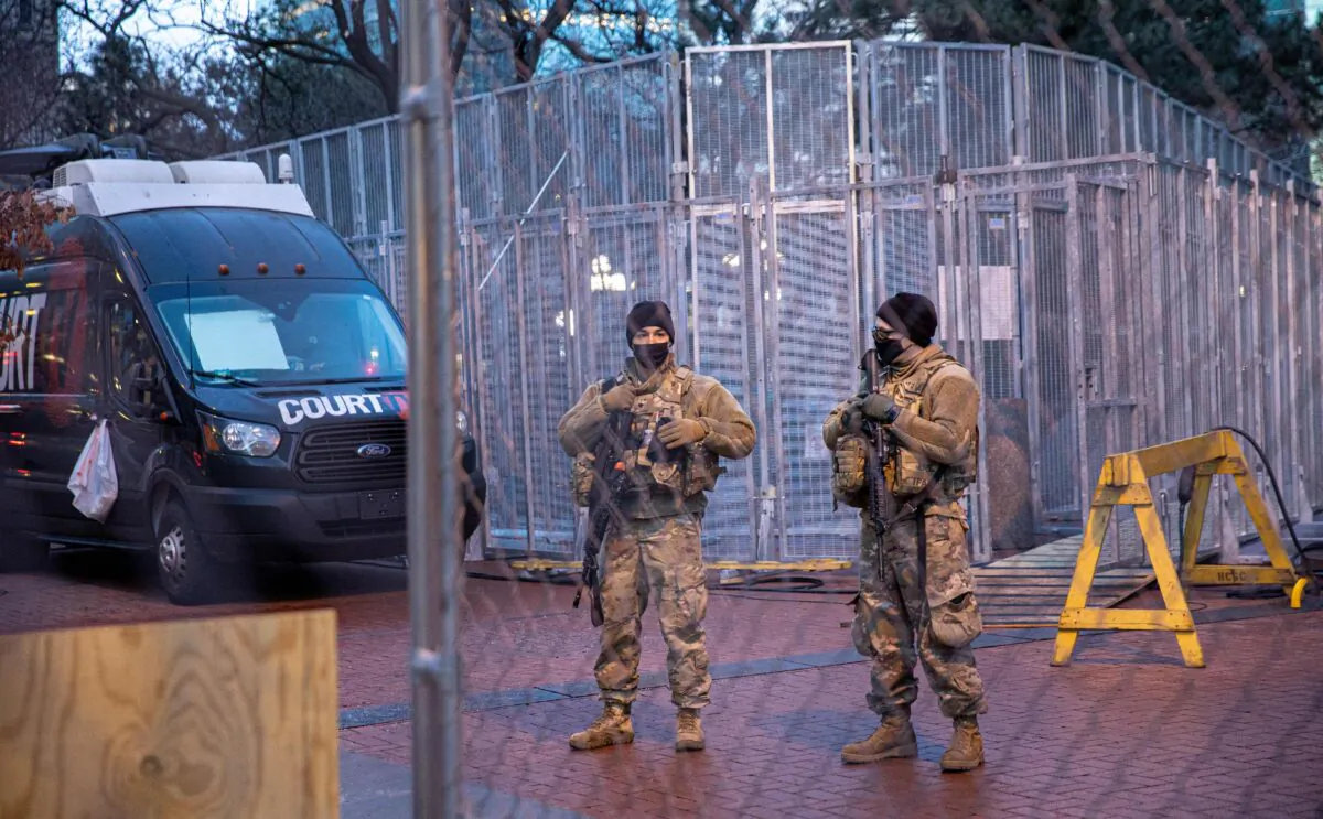Members of the National Guard stand behind a barbed wire fence perimeter surrounding the Hennepin County Government Center before jury selection begins at the trial of former Minneapolis Police officer Derek Chauvin in Minneapolis, on March 8, 2021. (Kerem Yucel/AFP via Getty Images)