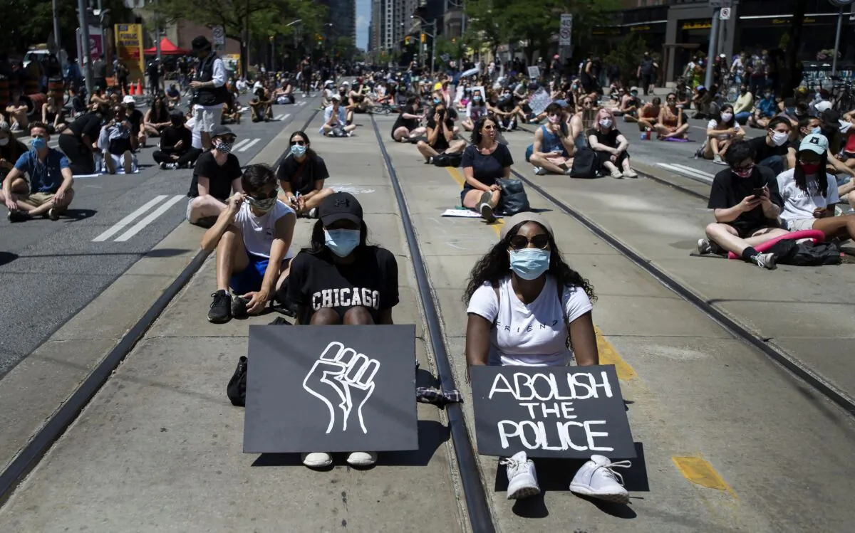 Thousands of people take part in a demonstration to defund the police in support of Black Lives Matter, in Toronto on June 19, 2020. (The Canadian Press/Nathan Denette)