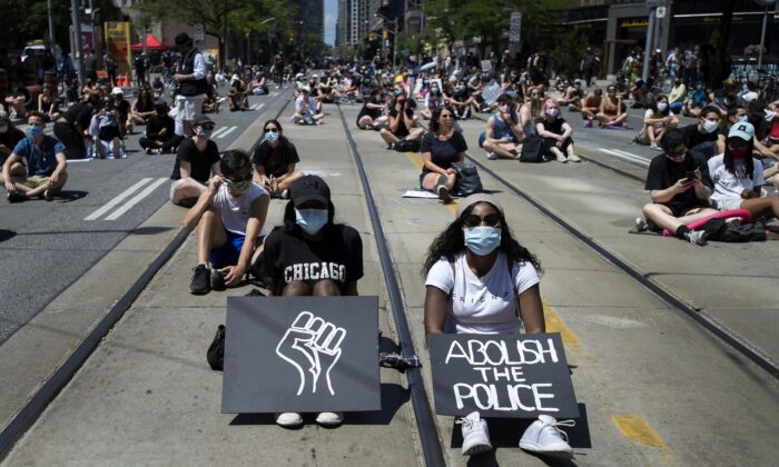 Thousands of people take part in a demonstration to defund the police in support of Black Lives Matter in Toronto, Canada, on June 19, 2020. (The Canadian Press/Nathan Denette)