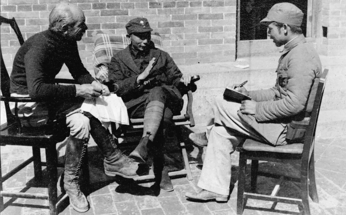A meeting between Dr. Norman Bethune (L) and Nieh Jung-chen (C), Commander-in-Chief of the Chin-Ch'a-Chi Border Region, in China in 1938. (National Archives of Canada/CP Photo)
