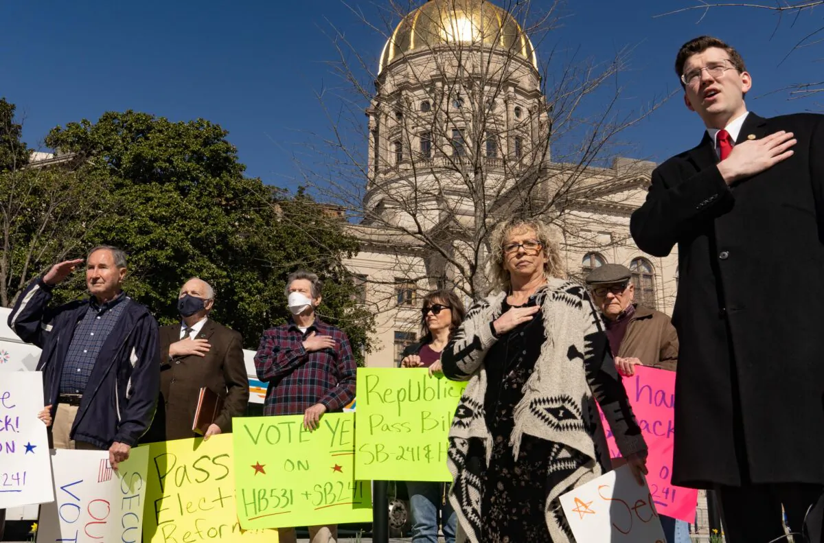 Demonstrators recite the Pledge of Allegiance at the Georgia Capitol building, while showing support of the HB 531 election reform bill in Atlanta, Ga., on March 3, 2021. (Megan Varner/Getty Images)
