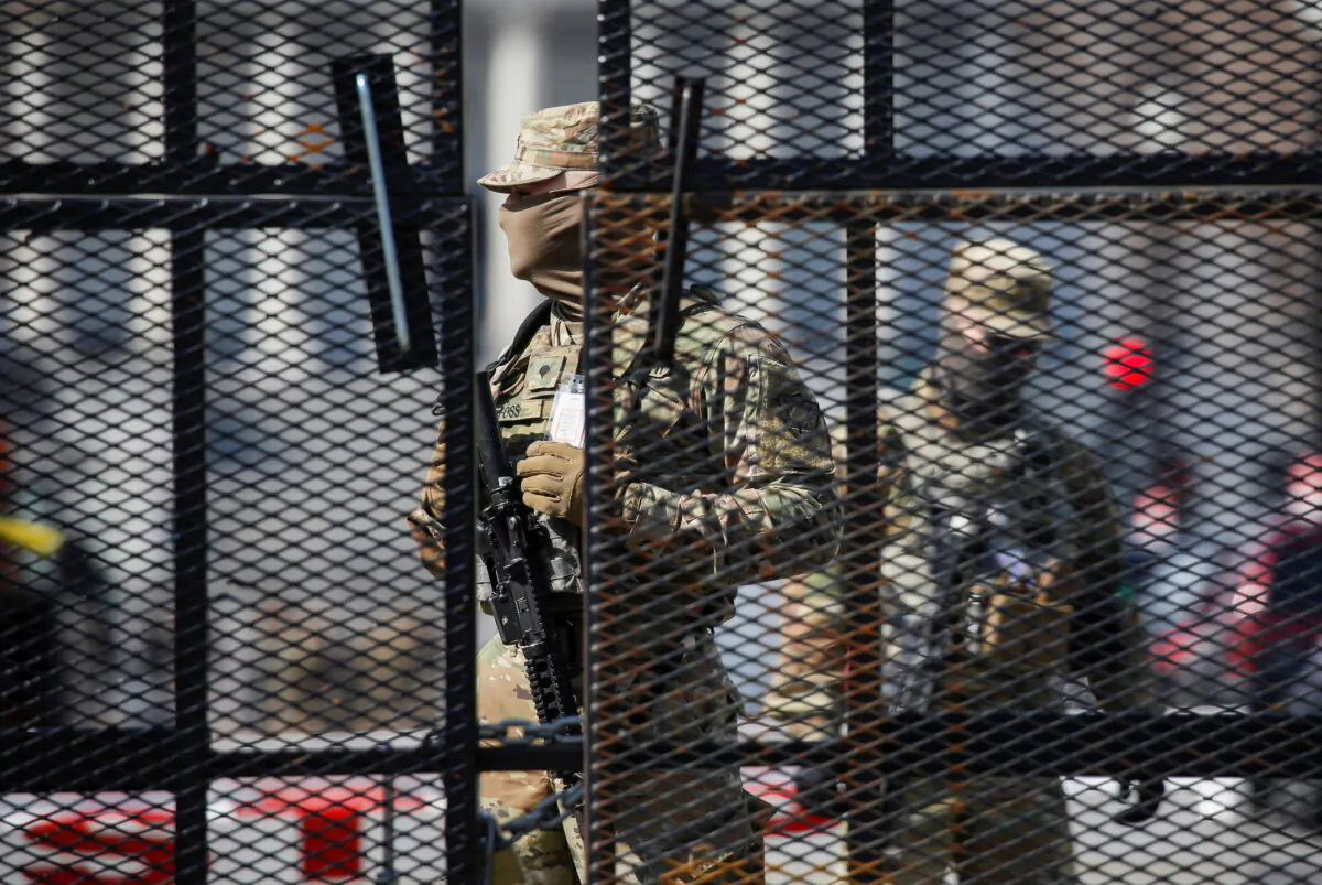 National Guard soldiers stand guard behind a security fence near the U.S. Capitol in Washington on March 4, 2021. (Jim Urquhart/Reuters)