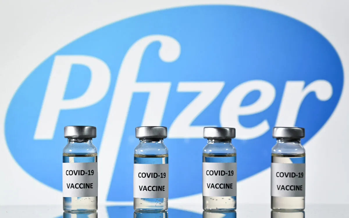 Vials with COVID-19 vaccine stickers attached, with the logo of U.S. pharmaceutical company Pfizer, on Nov. 17, 2020. (Justin Tallis/AFP via Getty Images)
