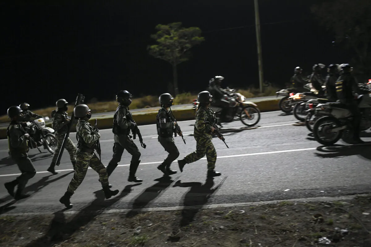 Security forces take part in a military drill to mark the eighth death anniversary of President Hugo Chavez in Caracas, Venezuela, on March 5, 2021. (Matias Delacroix/AP Photo)
