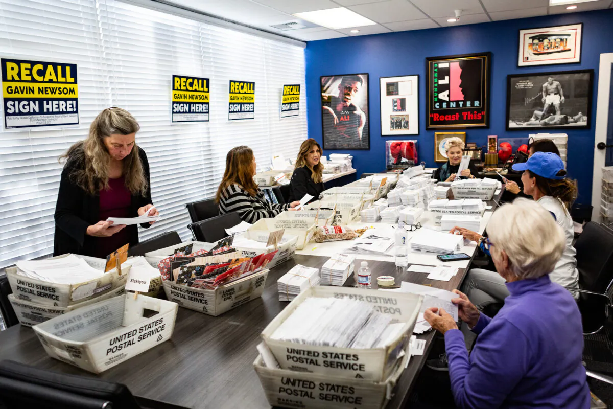 Volunteers sort recall mail to oust California Gov. Gavin Newsom at Capital Campaigns Incorporated in Newport Beach, Calif., on Jan 4, 2021. (John Fredricks/The Epoch Times)
