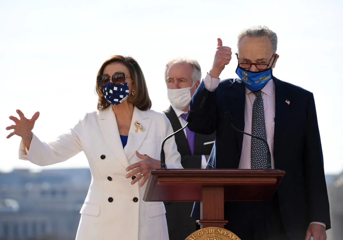 Speaker of the House Nancy Pelosi and Senate Majority Leader Chuck Schumer speak during the Bill Enrollment for the American Rescue Plan Act ceremony after the House Chamber voted on the final revised legislation of the $1.9 trillion COVID-19 relief plan, at the US Capitol in Washington, on March 10, 2021. (Olivier Douliery/AFP via Getty Images)