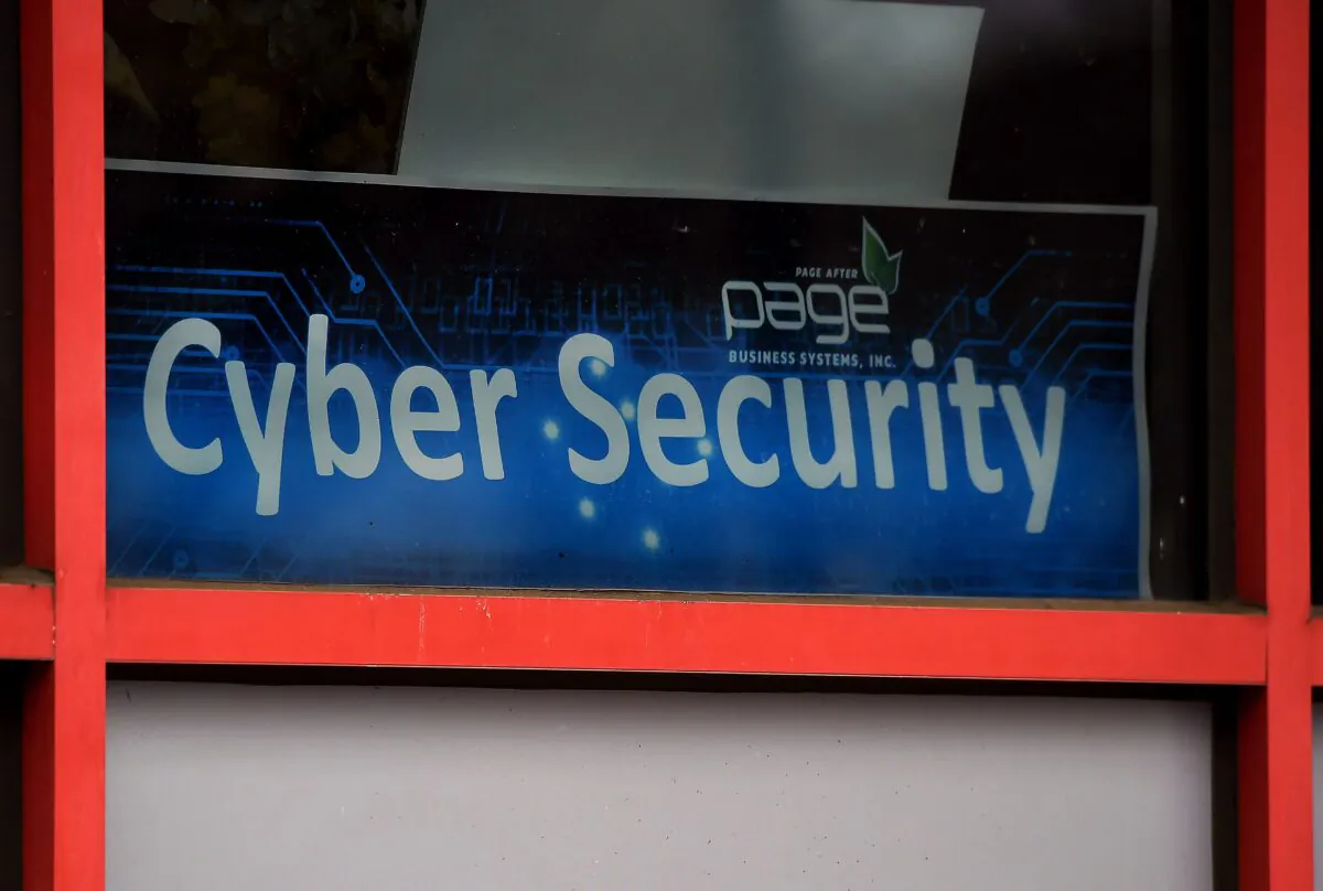 A cyber security sign is displayed in the window of a computer store on Dec. 18, 2020, in Arlington, Virginia. (Olivier Douliery/AFP via Getty Images)