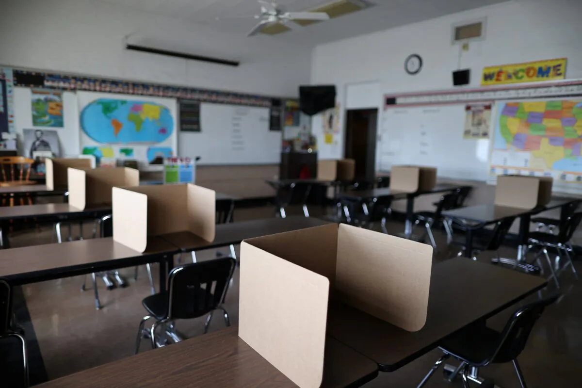 Social distancing dividers for students in a classroom at St. Benedict School in Montebello, near Los Angeles, on July 14, 2020. (Lucy Nicholson/Reuters)