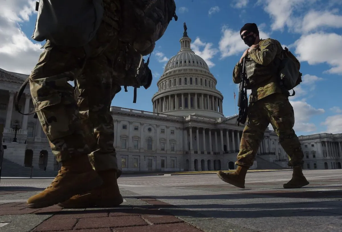 National Guard soldiers patrol the U.S. Capitol grounds on Capitol Hill in Washington on March 6, 2021. (Olivier Douliery/AFP via Getty Images)