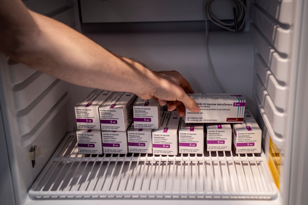 Staff member handles AstraZeneca COVID-19 vaccines in storage at Region Hovedstaden's Vaccine Center, Copenhagen, Denmark, on Feb. 11, 2021. (Ritzau Scanpix/Liselotte Sabroe via Reuters)