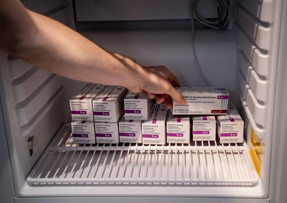 Staff member handles AstraZeneca COVID-19 vaccines in storage at Region Hovedstaden's Vaccine Center, Copenhagen, Denmark, on Feb. 11, 2021. (Ritzau Scanpix/Liselotte Sabroe via Reuters)