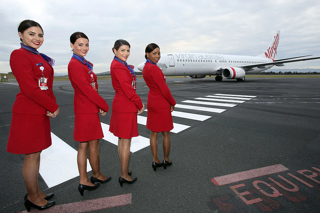 Virgin Australia cabin crew greet the chartered Virgin Australia flight as it arrives at Hobart International Airport on November 13, 2014 in Hobart, Australia. (Graham Denholm/Getty Images)