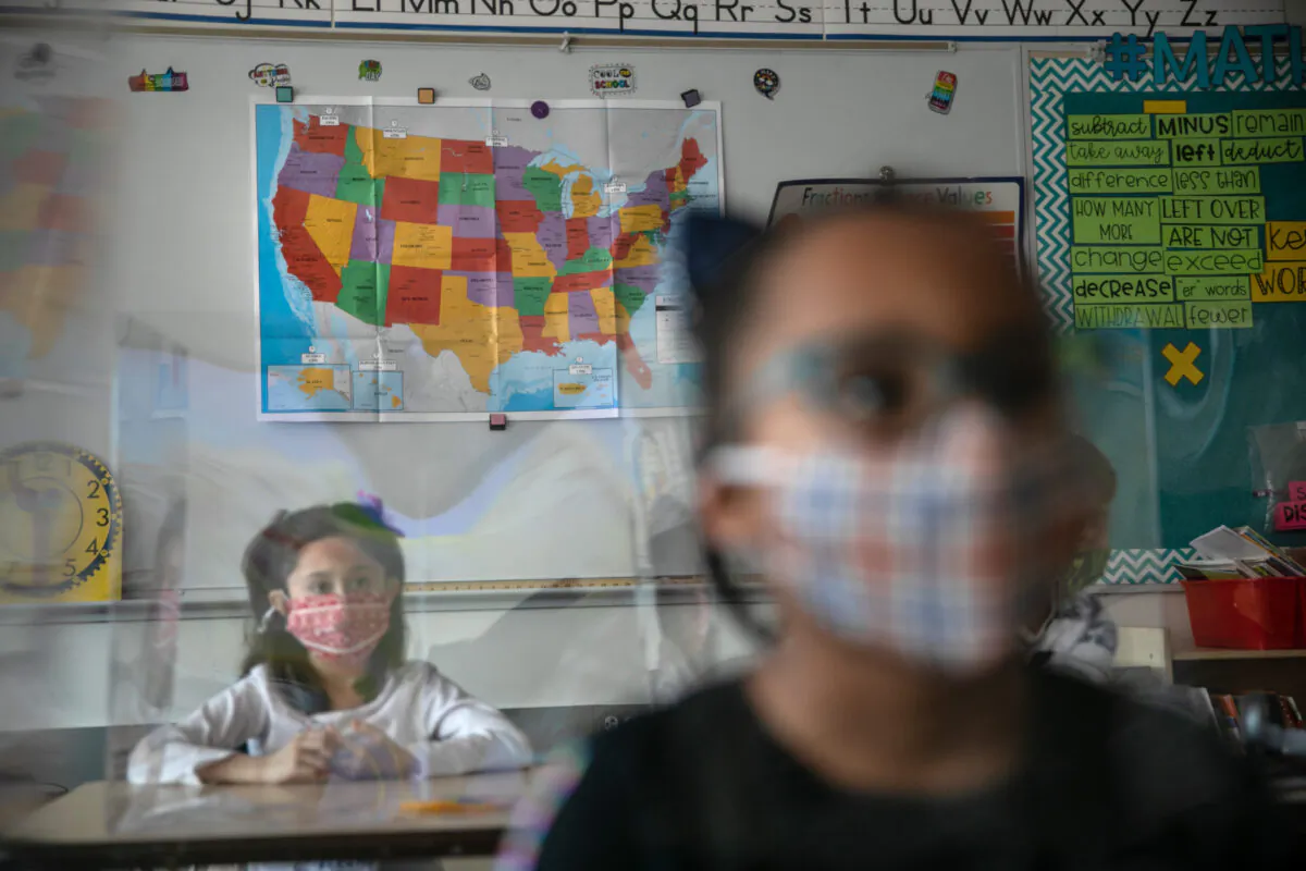 Third-grade students take part in class on the first day of in-person learning for five days per week at Stark Elementary School in Stamford, Conn., on March 10, 2021. (John Moore/Getty Images)
