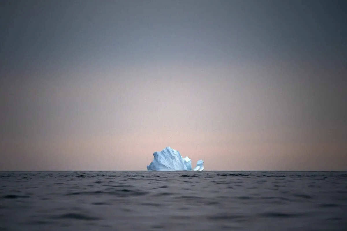 A large Iceberg floats away as the sun sets near Kulusuk, Greenland, on Aug. 15, 2019. (Felipe Dana/AP Photo)