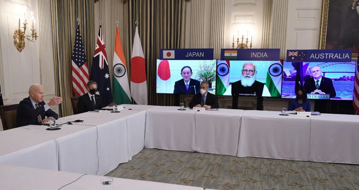 President Joe Biden (L), with Secretary of State Antony Blinken (2nd L), meets virtually with members of the "Quad" alliance of Australia, India, and Japan, in the State Dining Room of the White House on March 12, 2021. (Olivier Douliery/AFP via Getty Images)