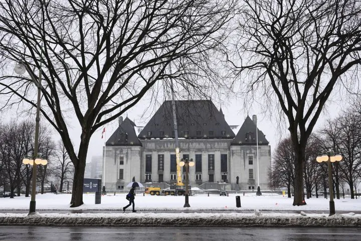 A pedestrian walks past the Supreme Court of Canada in Ottawa on Nov. 26, 2020. (Sean Kilpatrick/The Canadian Press)
