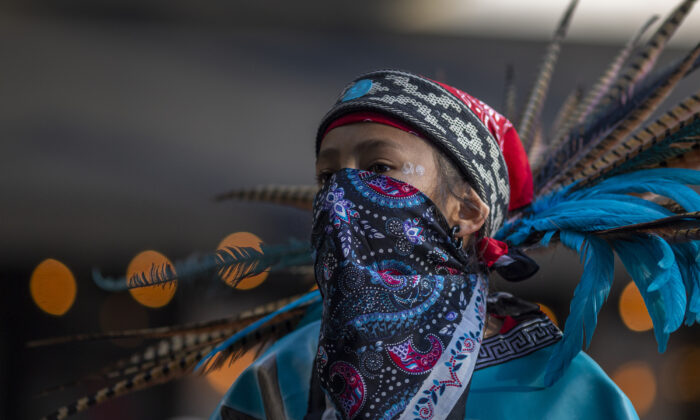 An Aztec dancer participates in a march on May 1, 2019 in Los Angeles, California. (David McNew/Getty Images)