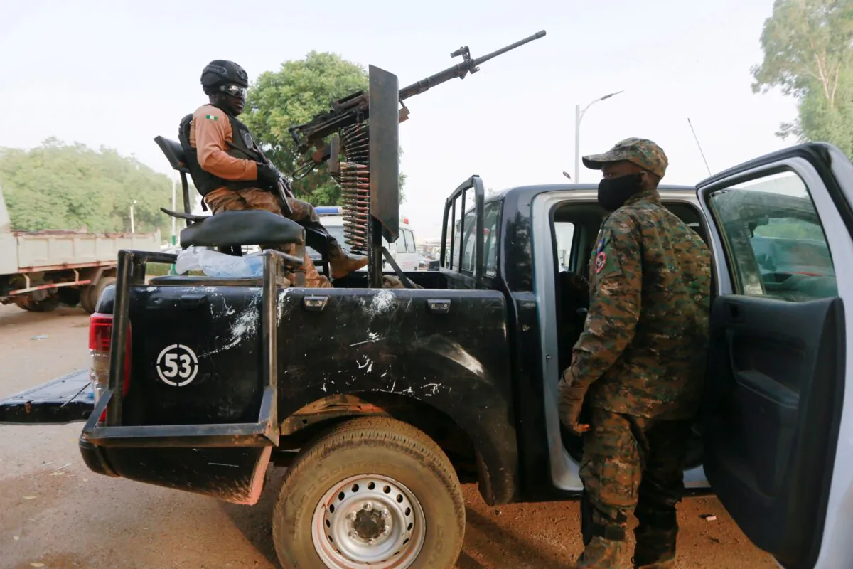A soldier sits on one of the trucks used to bring back the girls who were kidnapped from a boarding school in the northwest Nigerian state of Zamfara, following their release in Zamfara, Nigeria, March 2, 2021. (Afolabi Sotunde/Reuters)
